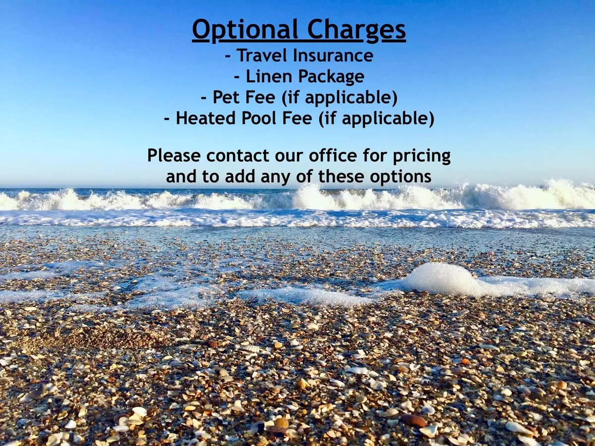A stunning view of the ocean waves gently rolling onto a sandy beach, with scattered shells visible along the shore. The scene is tranquil, evoking the feeling of stepping straight from your accommodation onto the inviting coastline. The beach stretches into the distance, perfect for swimming, sandcastle building, or leisurely walks.