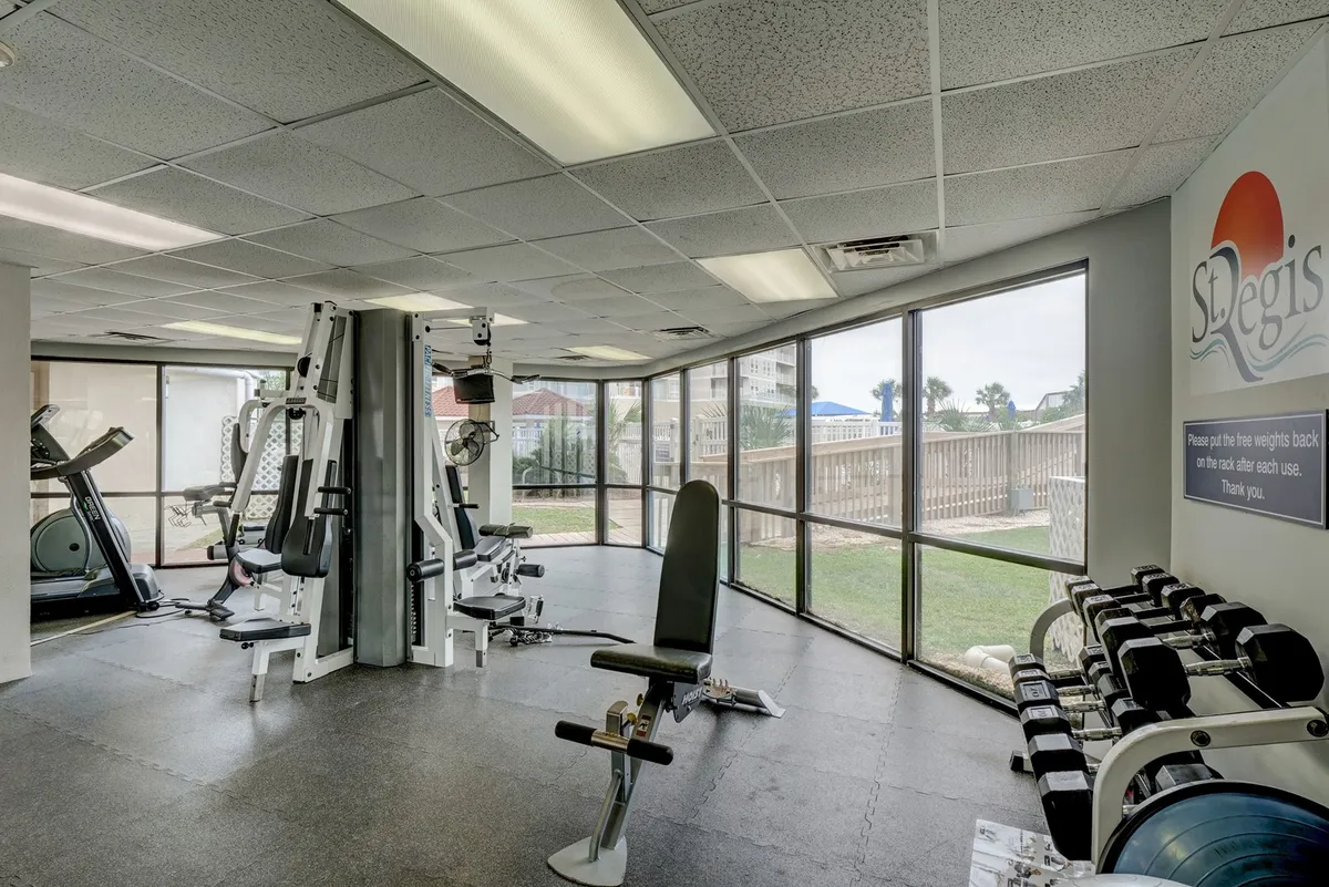 A bright, modern fitness center filled with exercise equipment, large windows, and a motivational wall graphic. The space is energizing and designed for guests to maintain their workout routines or start the day with invigorating exercise.